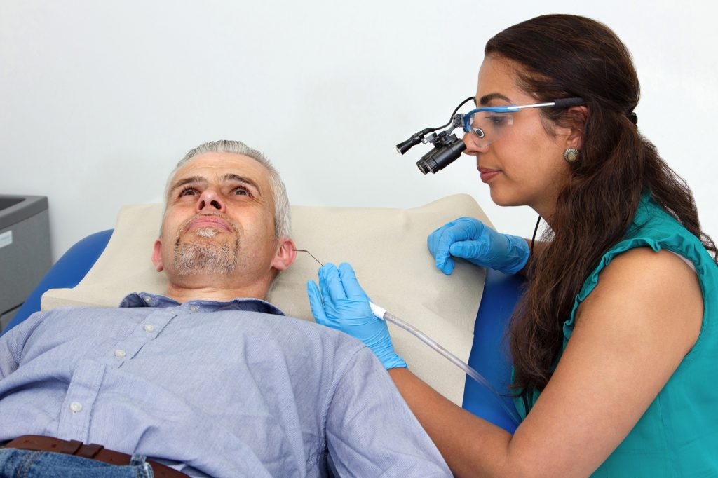 Using loupes for earwax removal by microsuction